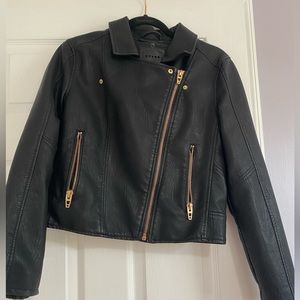 Blank NYC black leather jacket with rose gold zipper accents.